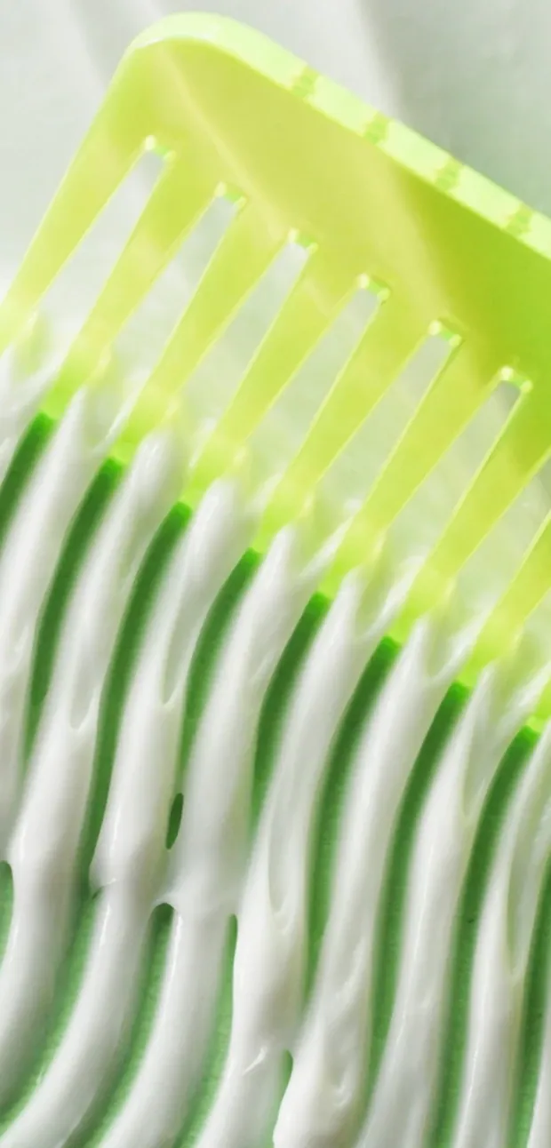 image showing conditioner, scalp scrub, shampoo and marula tangle spray products on a colourful background